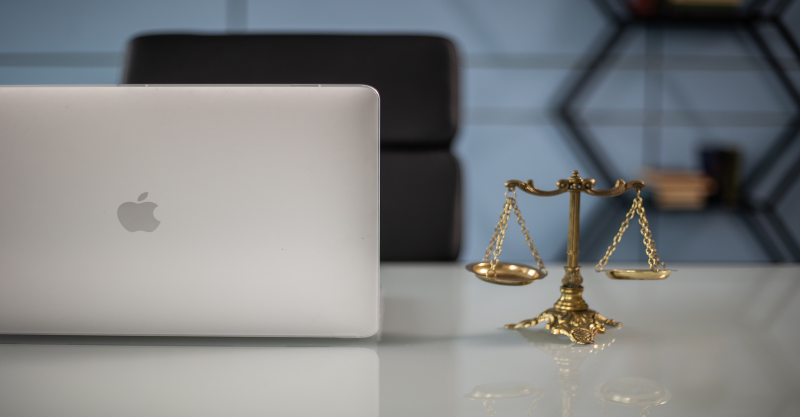 Scales of Justice alongside Computer